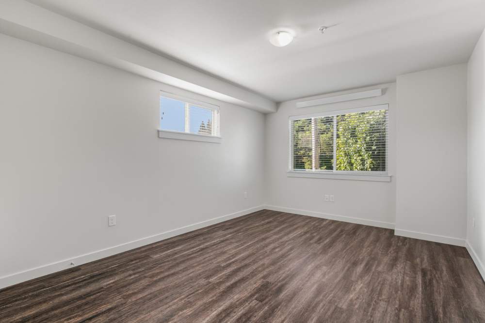 Bedroom with a large window at Blanton Commons in Beaverton, Oregon