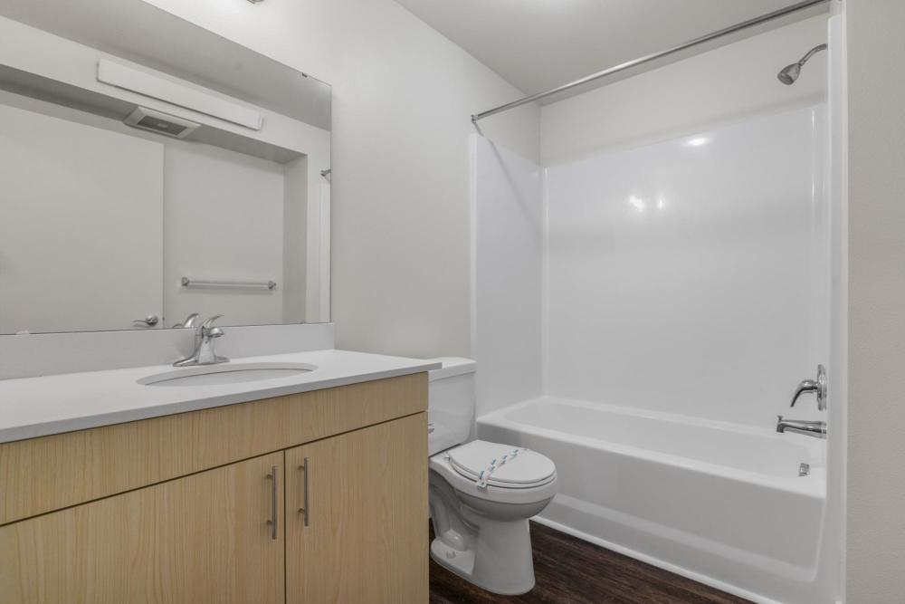 Bathroom with a toilet and a large mirror at Blanton Commons in Beaverton, Oregon