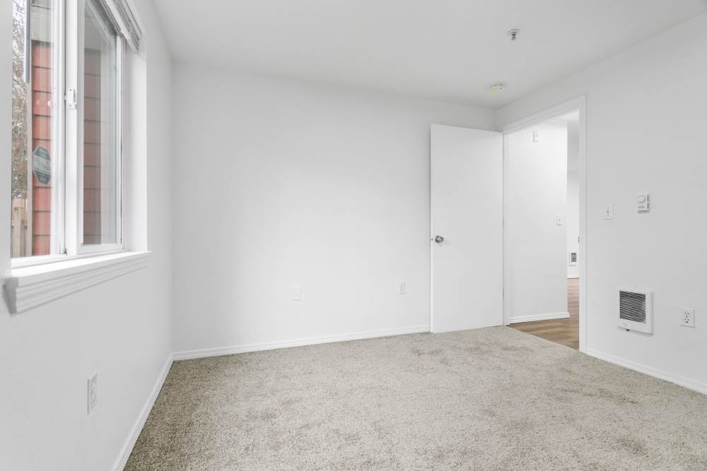 Unfurnished apartment room with a window and carpet flooring at Reedville Meadows in Beaverton,Oregon