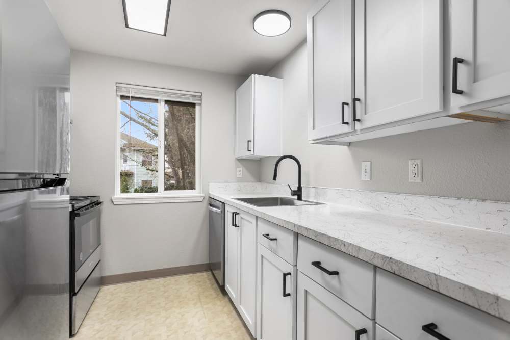 Cozy kitchen with white cabinetry and stainless-steel appliances at Reedville Meadows in Beaverton,Oregon