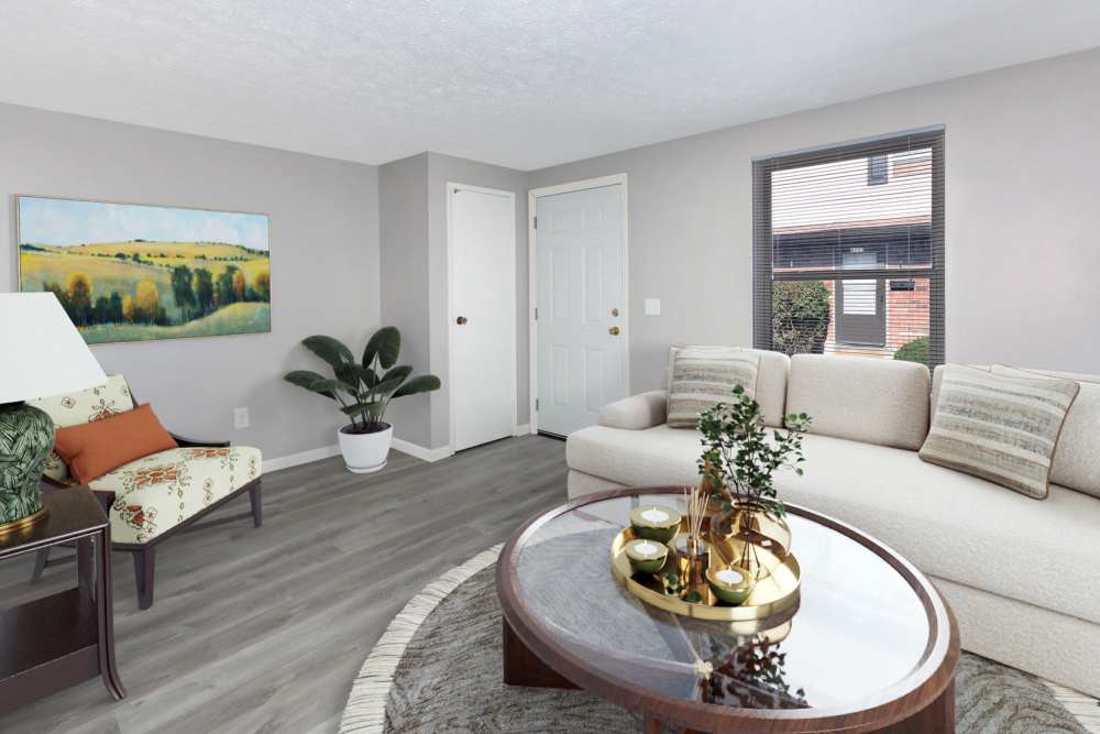 Living area with center table and large window at North Eden Townhomes in Columbus, Ohio