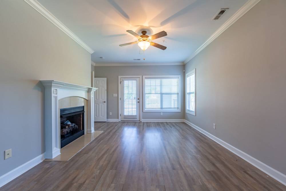 Unfurnished living room with ceiling fan at Amelia Apartments in Fayetteville, North Carolina