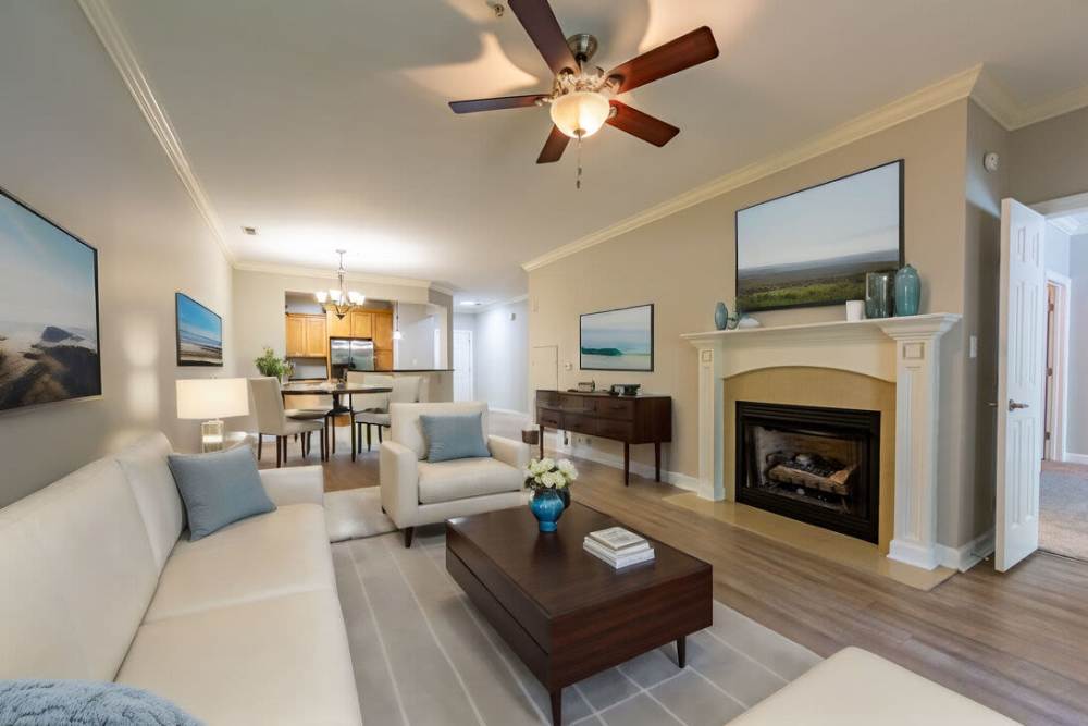 Living room with fireplace and wall art at Amelia Apartments in Fayetteville, North Carolina
