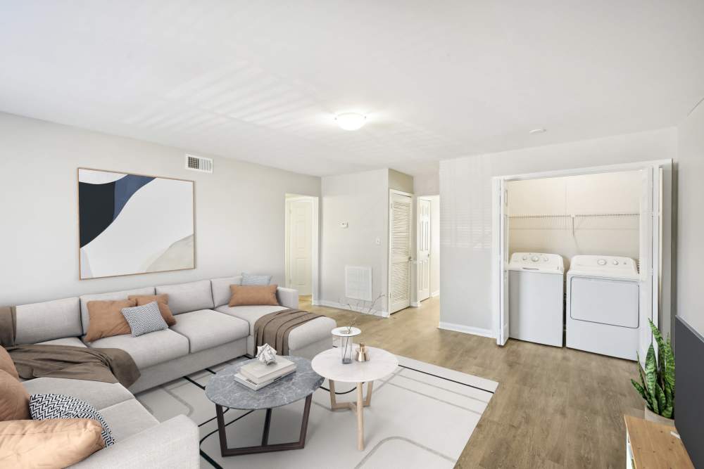 Living room with wood-style flooring at Amber Grove Apartment Homes in Marietta, Georgia