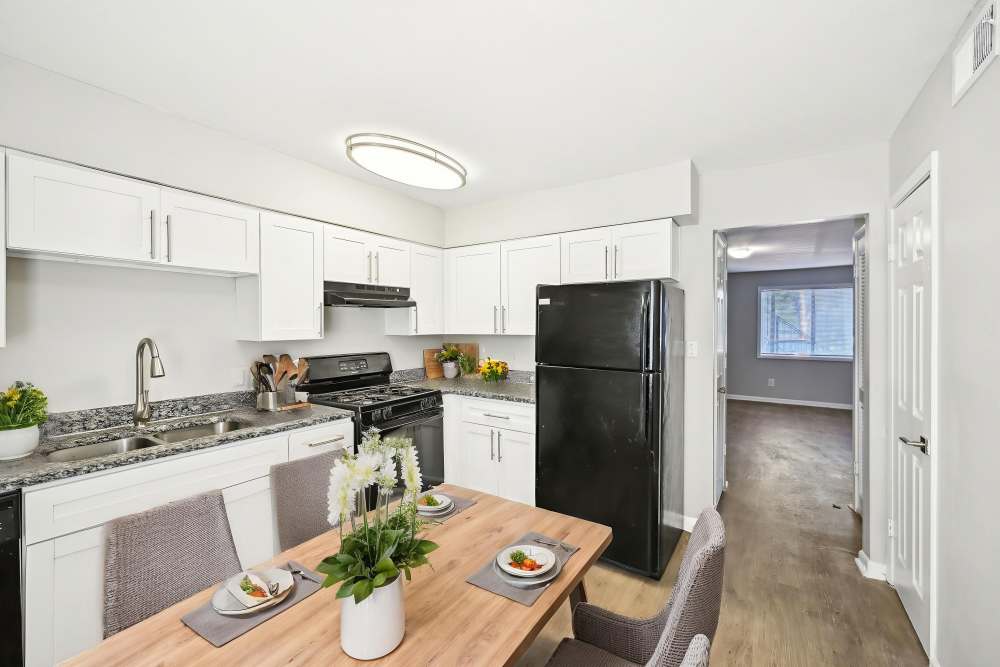 Kitchen with black appliances at Amber Grove Apartment Homes in Marietta, Georgia