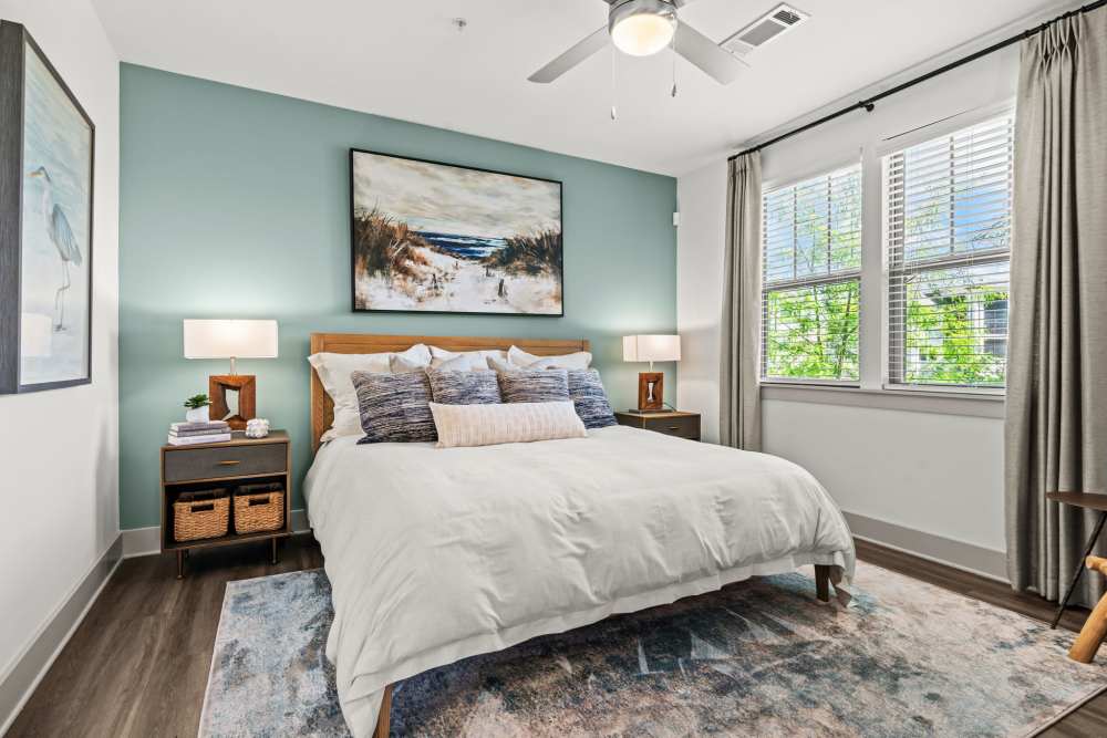 Ambient bedroom with large bed and window for natural lighting at Watersound Origins Crossings in Inlet Beach, Florida