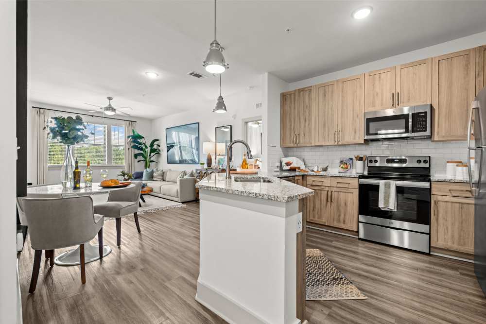 Kitchen with sink and view to living room at Watersound Origins Crossings in Inlet Beach, Florida