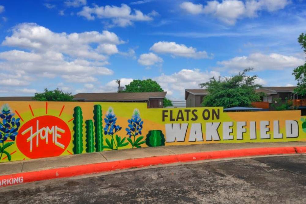 Unique wall painting with property signage at Flats On Wakefield in San Antonio,Texas