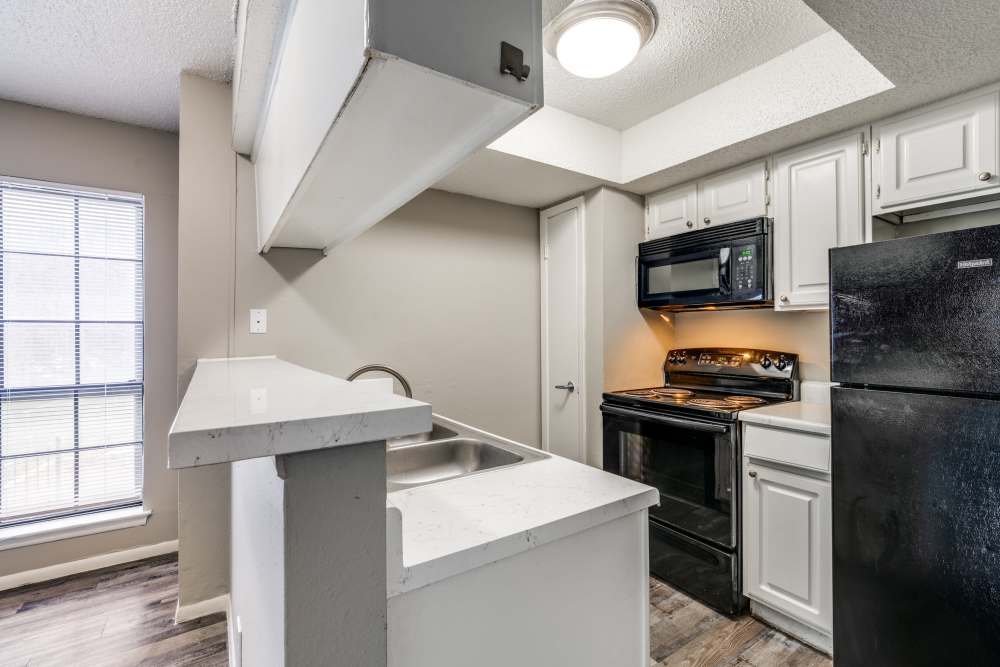 Kitchen with white granite countertop at Icon Apartments in San Antonio,Texas