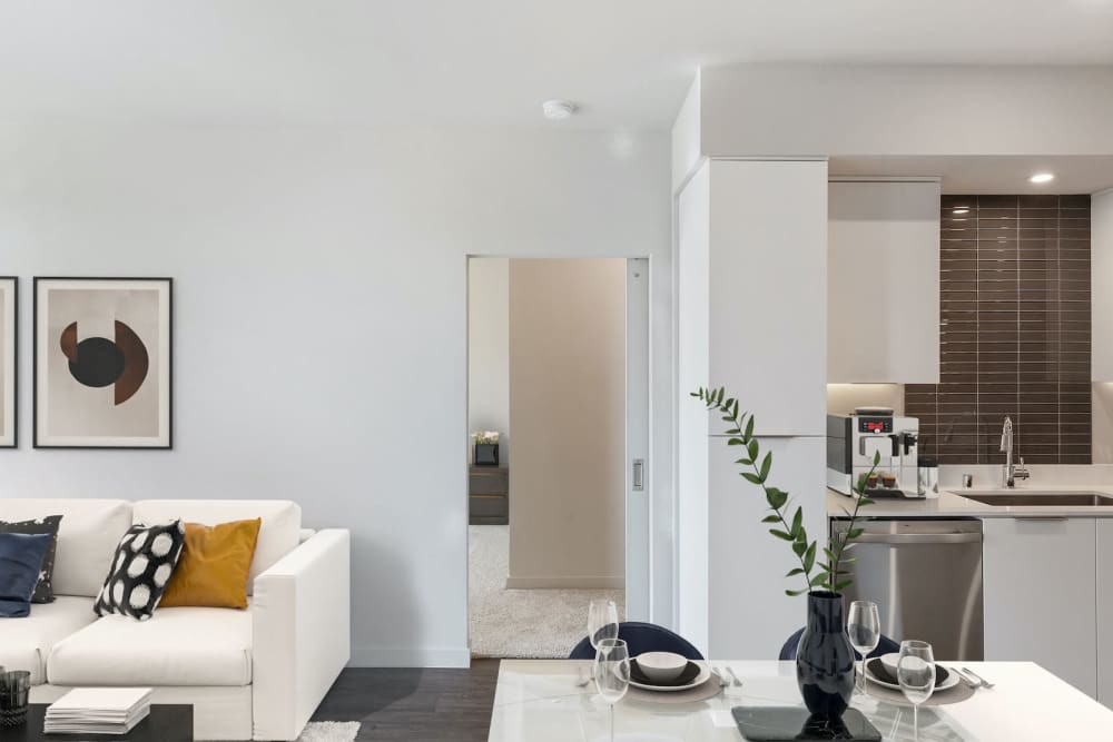 Modern finishes in an apartment living room and dining/kitchen area at The Fields in Milpitas, California