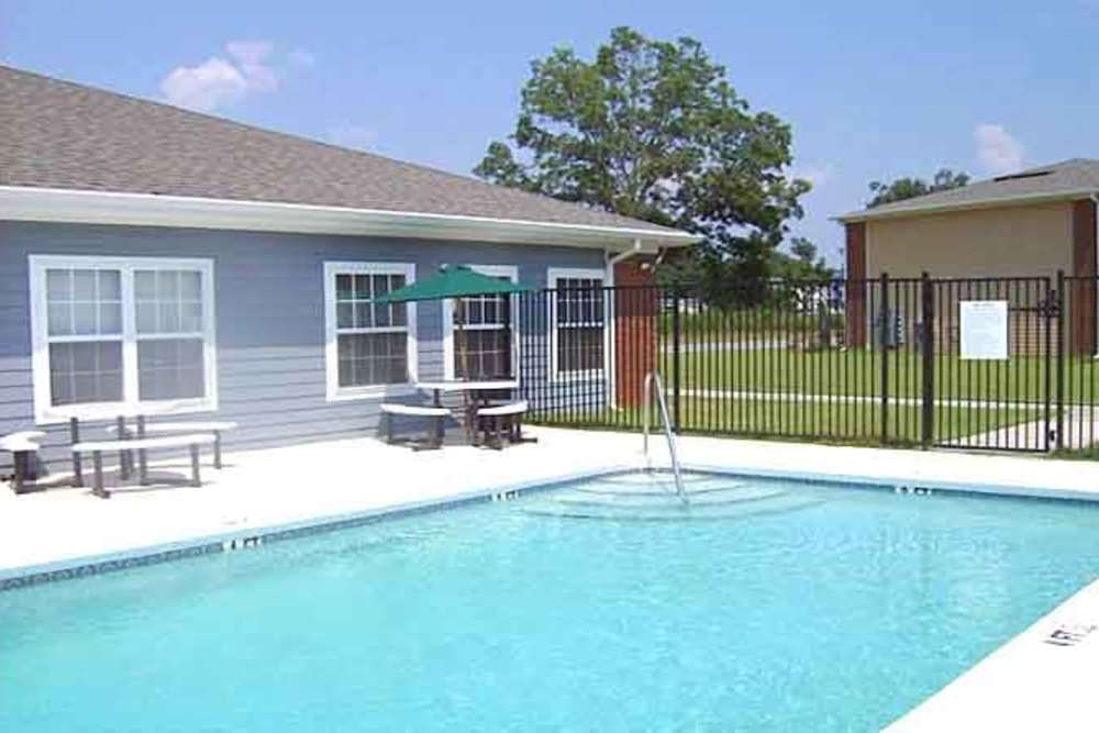 Swimming pool in front of the apartment building at Ochlockonee Pointe Apartments in Midway, Florida