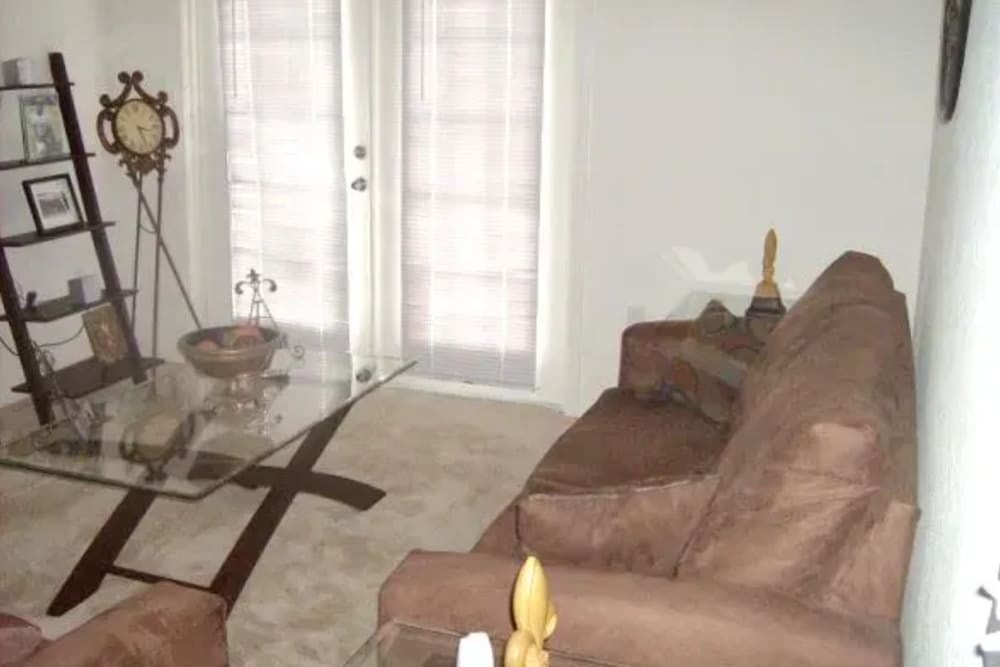 Living room with a comfortable couch at Ochlockonee Pointe Apartments in Midway, Florida