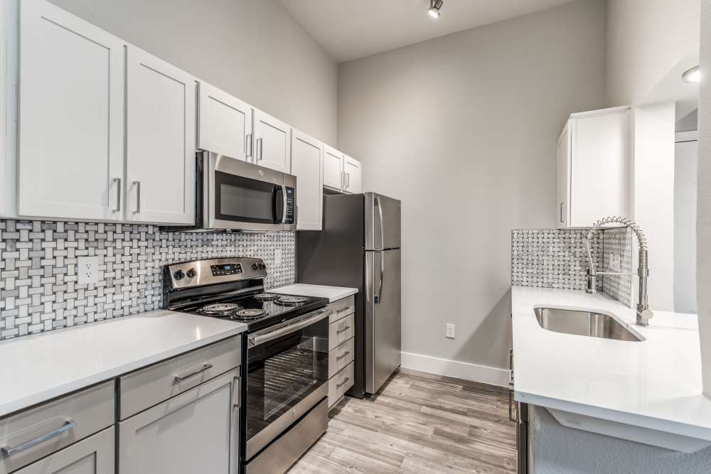 Modern kitchen with wooden cabinets at The Biltmore in The Woodlands, Texas