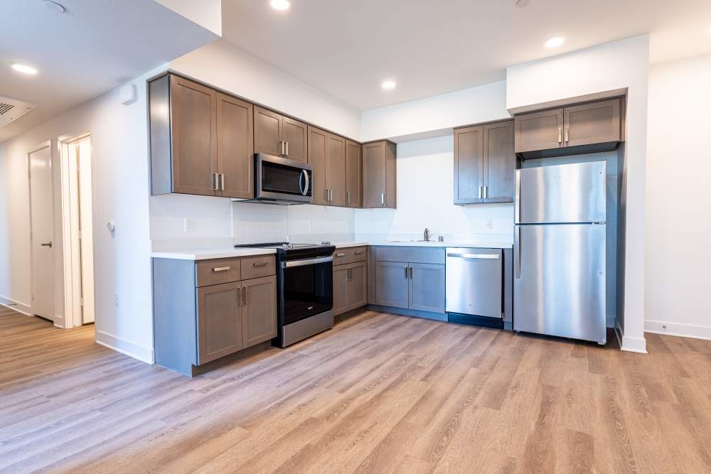 A modern kitchen featuring stainless steel appliances at Monamos Terrace Apartments in Murrieta, California