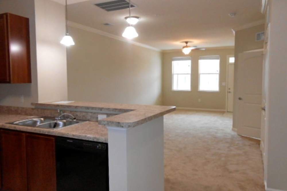Living room and kitchen in a home at Ellsworth Commons Apartments in Greenville, North Carolina