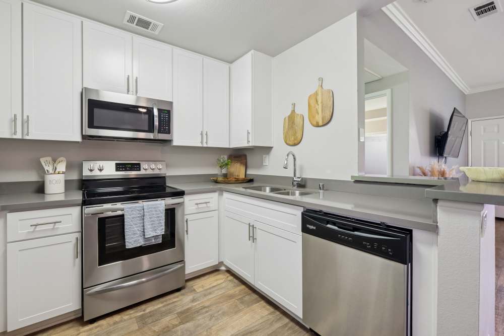 Large luxury kitchen with white cabinetry and stainless-steel appliances at Paloma Summit Condominium Rentals in Foothill Ranch, California
