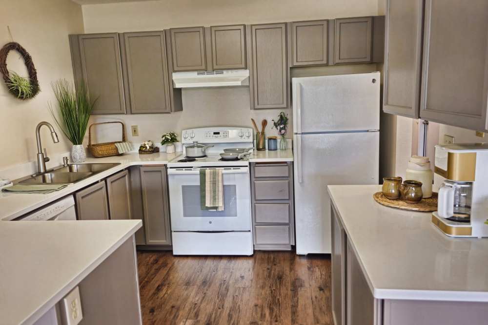 A modern kitchen displaying a sink, stove, and refrigerator at Neawanna By The Sea in Seaside, Oregon