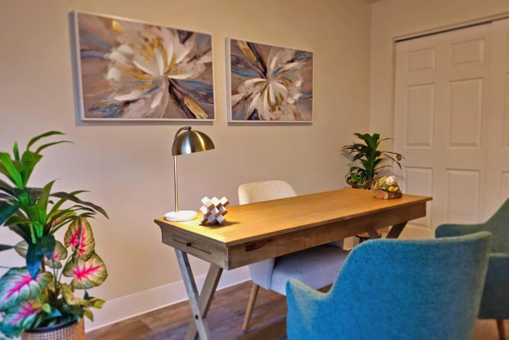 A small office featuring a desk and two chairs arranged for a workspace setting at Neawanna By The Sea in Seaside, Oregon