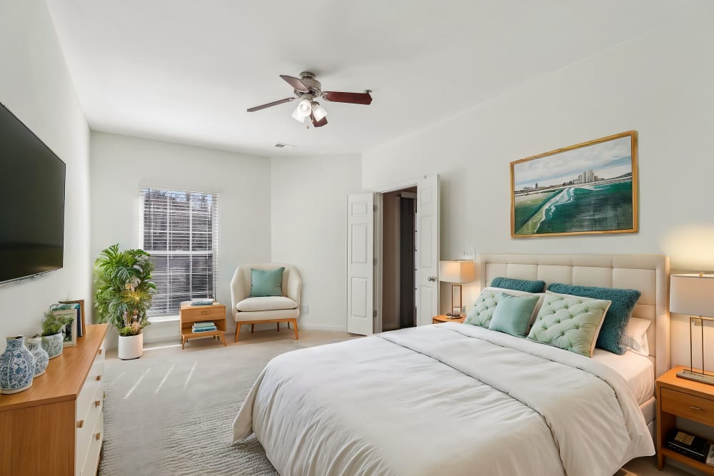Cozy bedroom with ceiling fan at Malvern Lakes Apartments in Fredericksburg, Virginia