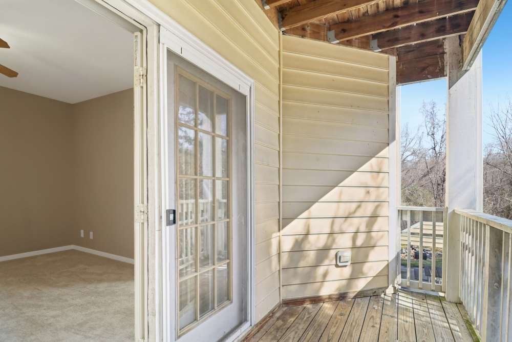 Patio with wooden railing at Malvern Lakes Apartments in Fredericksburg, Virginia