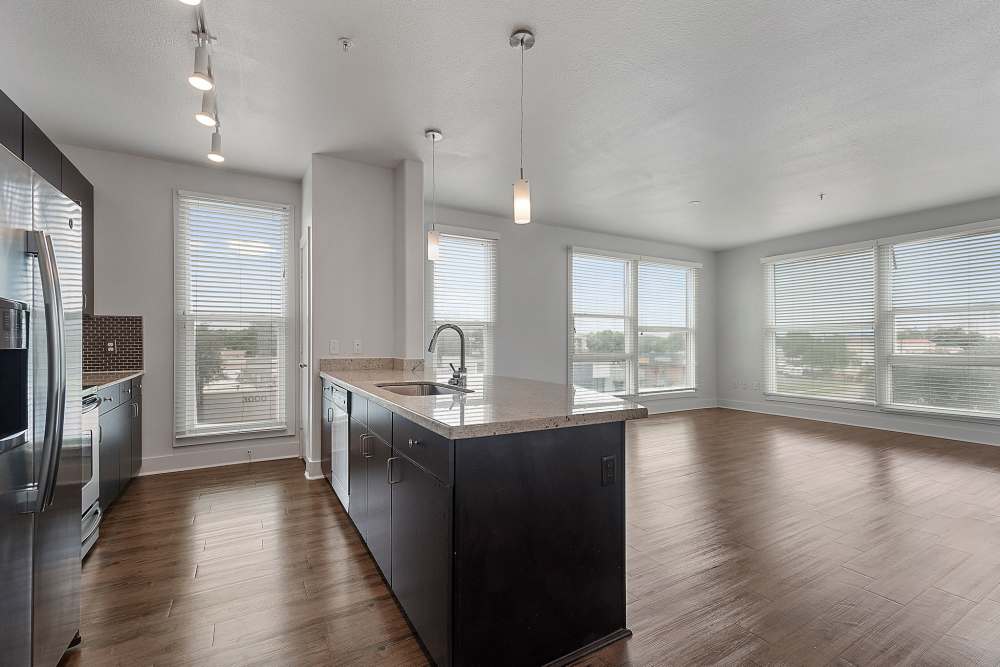 Living room with connecting kitchen at The Lofts At West 7th in Fort Worth, Texas