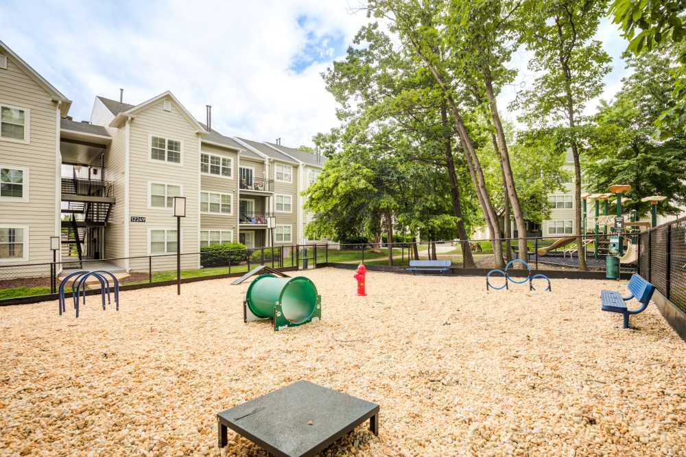 Onsite dog park beside the apartment building at Knoll at Fair Oaks in Fairfax, Virginia