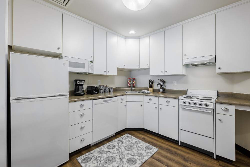 Kitchen with white cabinets and appliances at Truewood by Merrill, Vancouver in Vancouver, Washington
