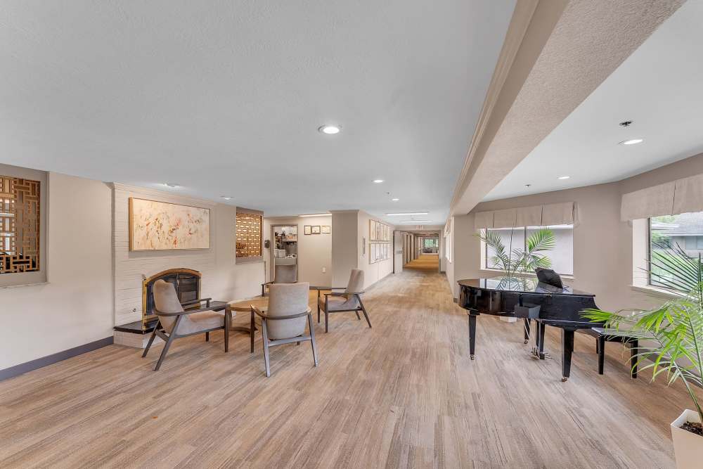 Lounge with tables and a grand piano at Regency House by Barclay House in Decatur, Georgia
