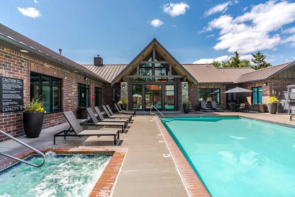 Swimming pool and lounge chairs in the daylight at Avery at Orenco Station in Hillsboro, Oregon