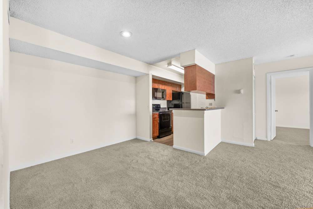 Living room with close access to kitchen at Clipper Cove Apartments in Boynton Beach, Florida