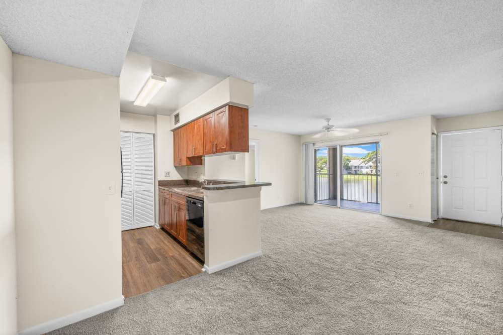 Kitchen with access to living room at Clipper Cove Apartments in Boynton Beach, Florida