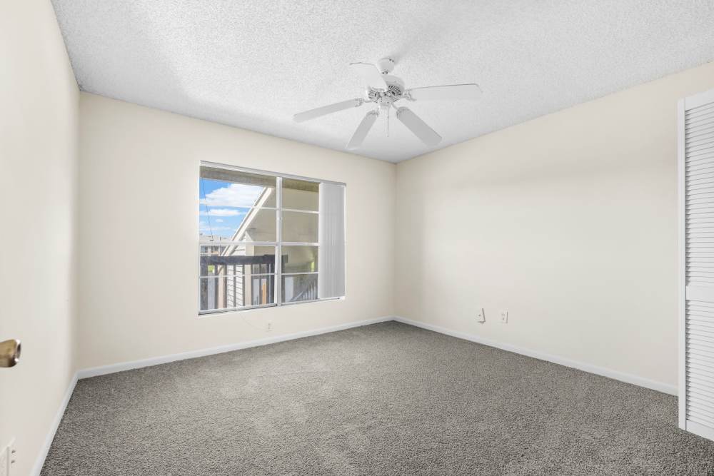 Bedroom with window at Clipper Cove Apartments in Boynton Beach, Florida
