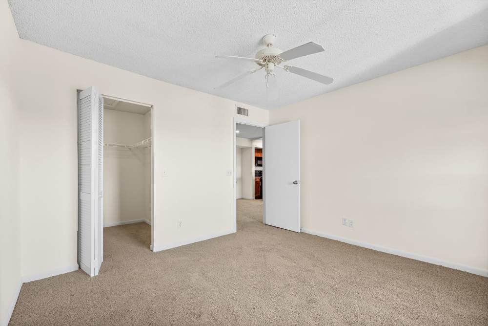 Bedroom with plush carpeting at Clipper Cove Apartments in Boynton Beach, Florida