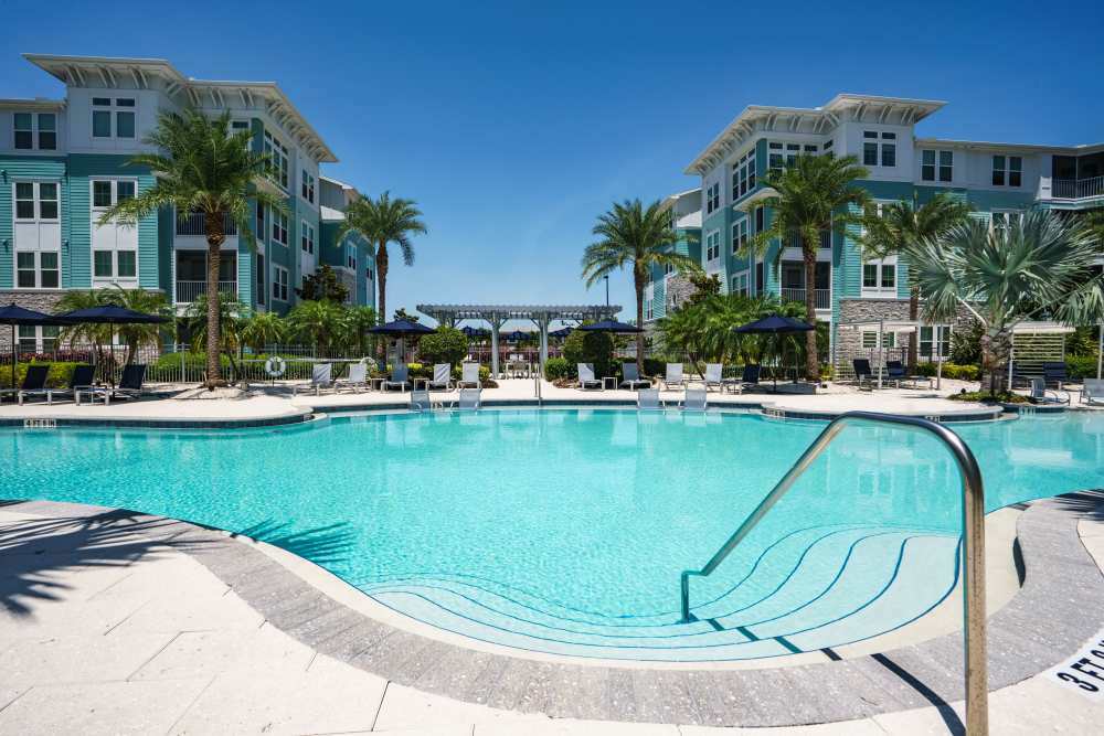 A sparkling outdoor swimming pool at The Addison Skyway Marina in St. Petersburg, Florida