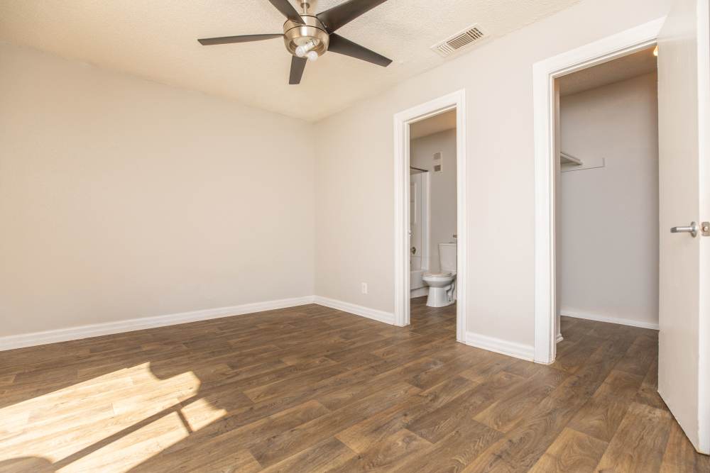 Wood-style flooring with closet in the room at Fredericksburg Place Apartments in San Antonio, Texas