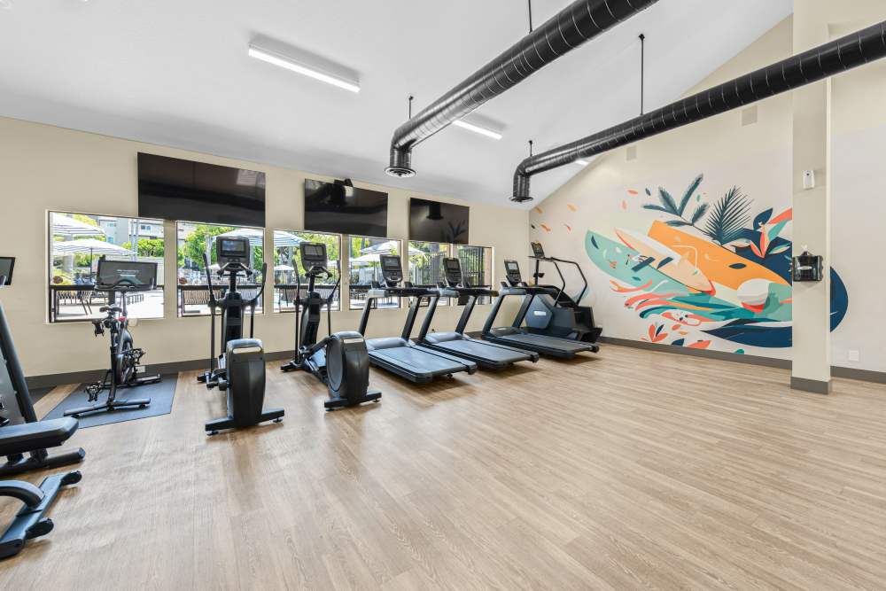 Large fitness center with various workout equipment at Allina La Jolla in San Diego, California