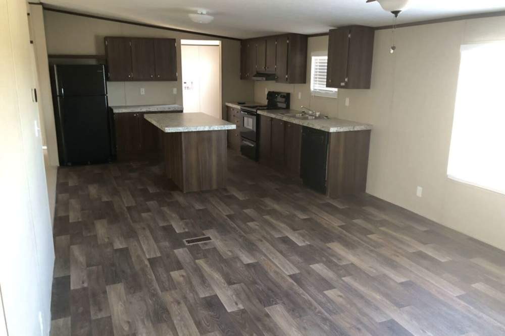 Spacious kitchen with wooden cabinets at IC Creek Ranch in Leonard, Texas