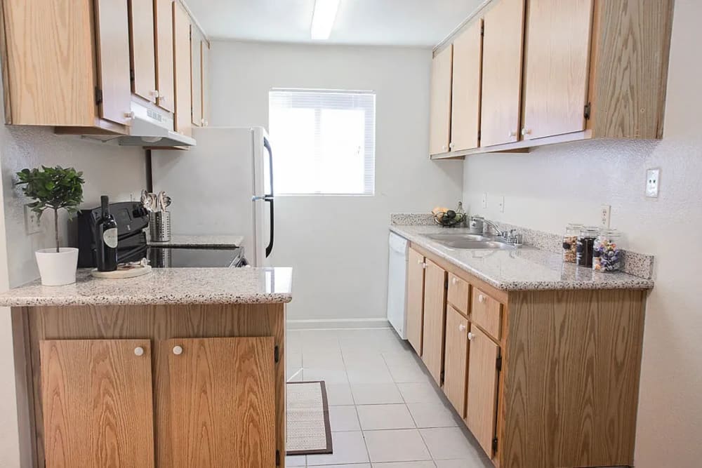 Kitchen with wooden cabinetry at Walnut Apartments in Santa Rosa, California