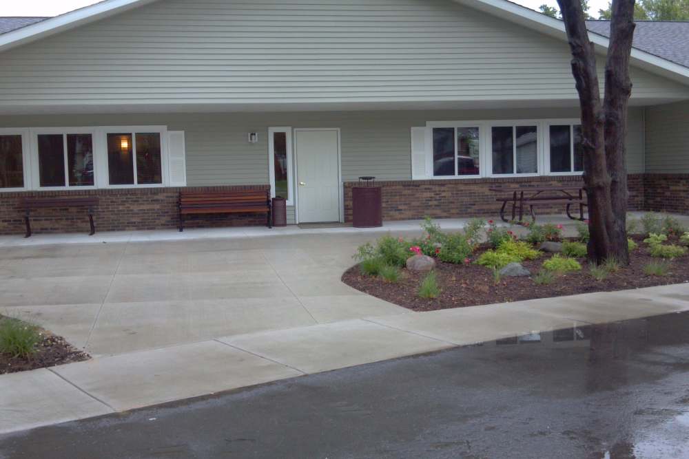 Community exterior view with side walk at Rolling Brook Apartments in Algonac, Michigan