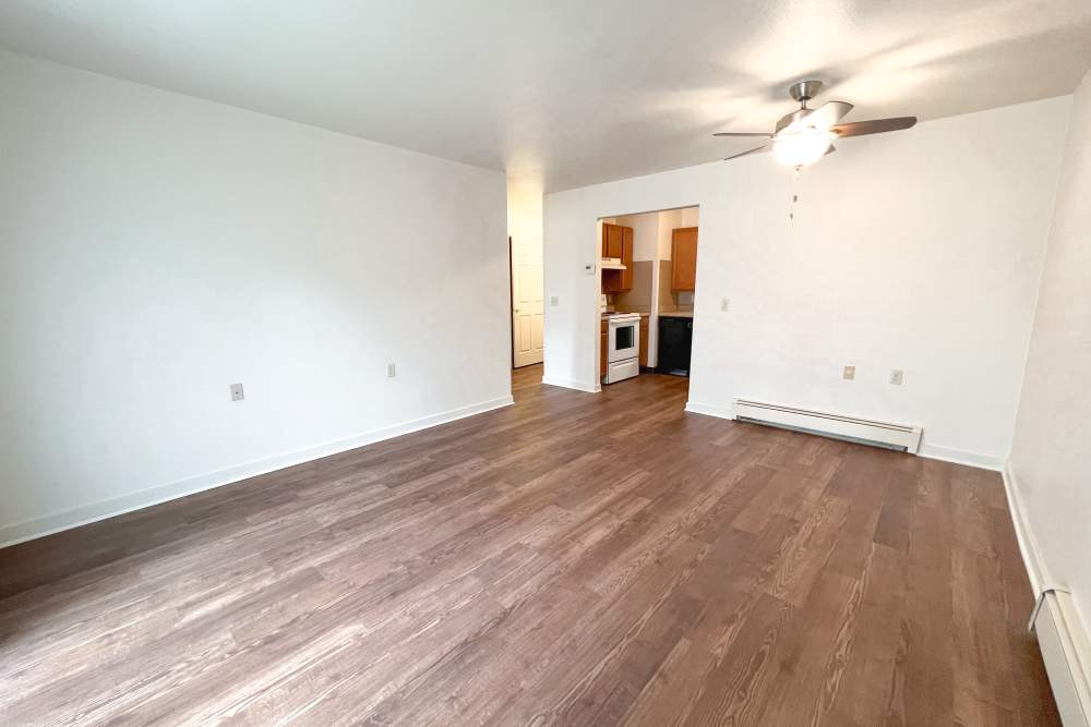 Unfurnished living room with view to kitchen at Rolling Brook Apartments in Algonac, Michigan 