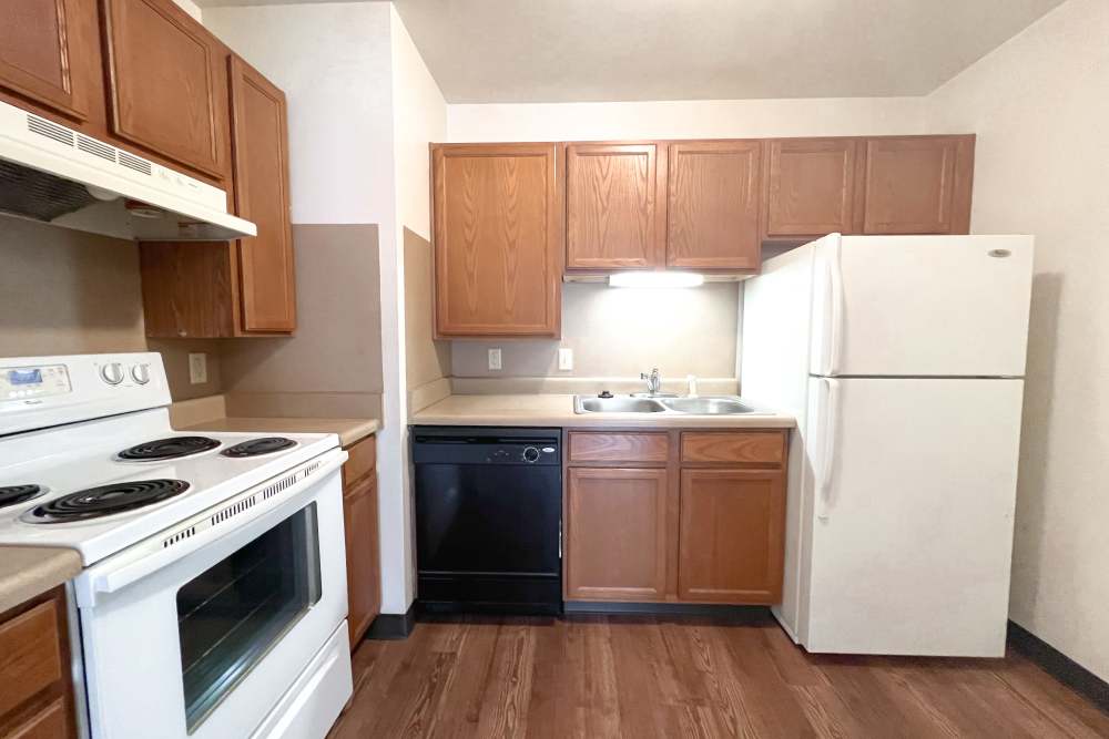 Kitchen with white color appliance at Rolling Brook Apartments in Algonac, Michigan