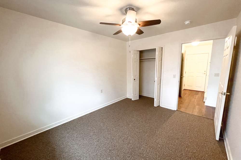 Bedroom with attached closet at Rolling Brook Apartments in Algonac, Michigan