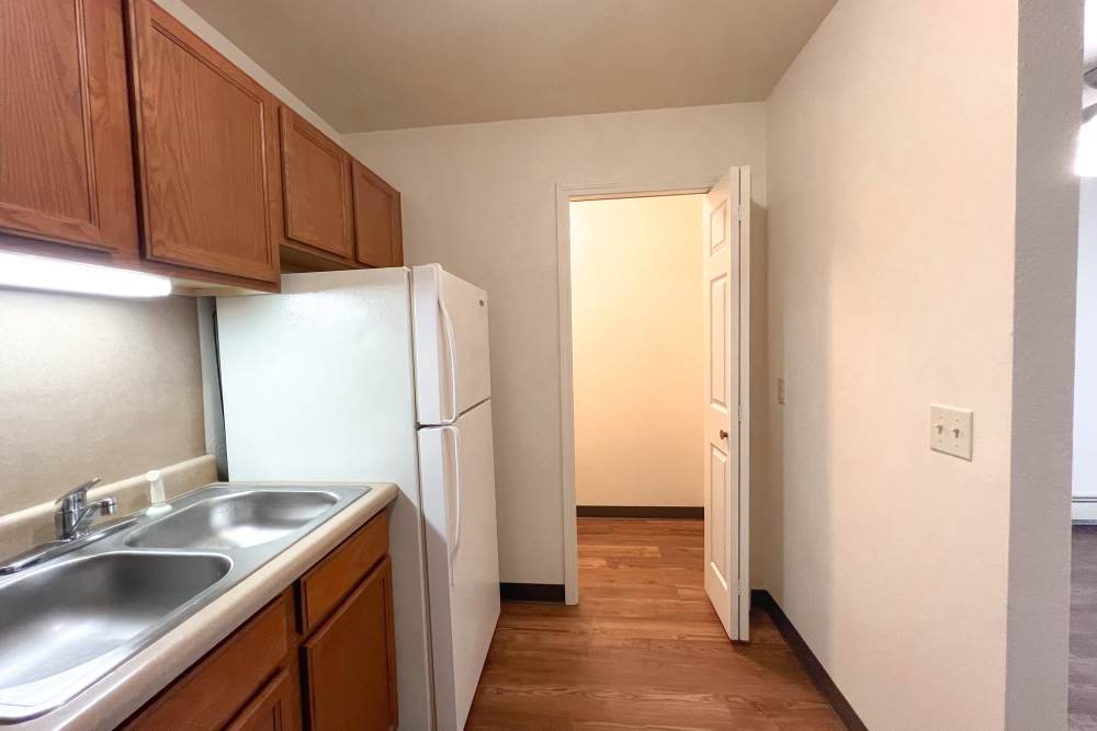 Kitchen with wooden flooring at Rolling Brook Apartments in Algonac, Michigan