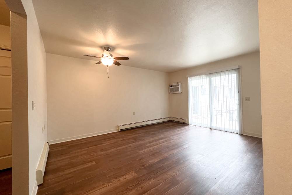 Unfurnished living room with ceiling fan at Rolling Brook Apartments in Algonac, Michigan