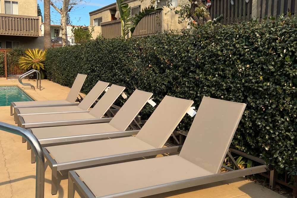 Chairs by the pool at Alpine Terrace Apartments in Canoga Park, California
