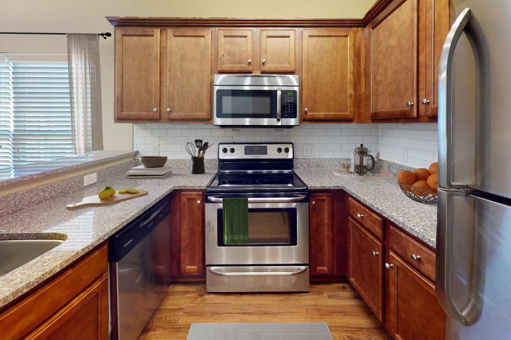 Kitchen with custom cherry cabinets at Sage Creek Apartments in Augusta, Georgia