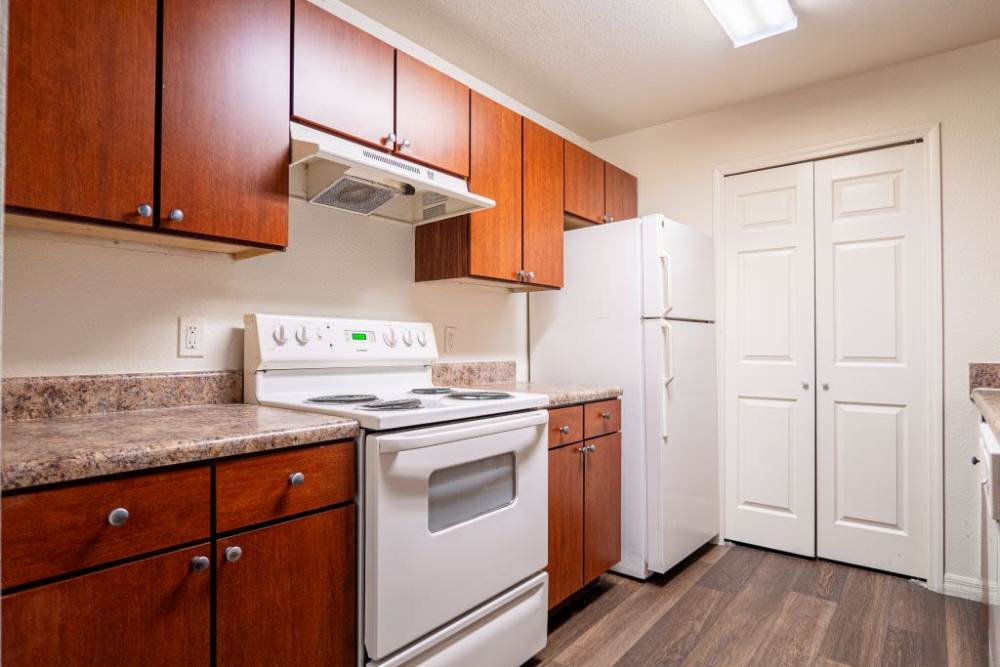 Fully equipped kitchen with wood-style flooring at Clarcona Groves in Orlando, Florida,