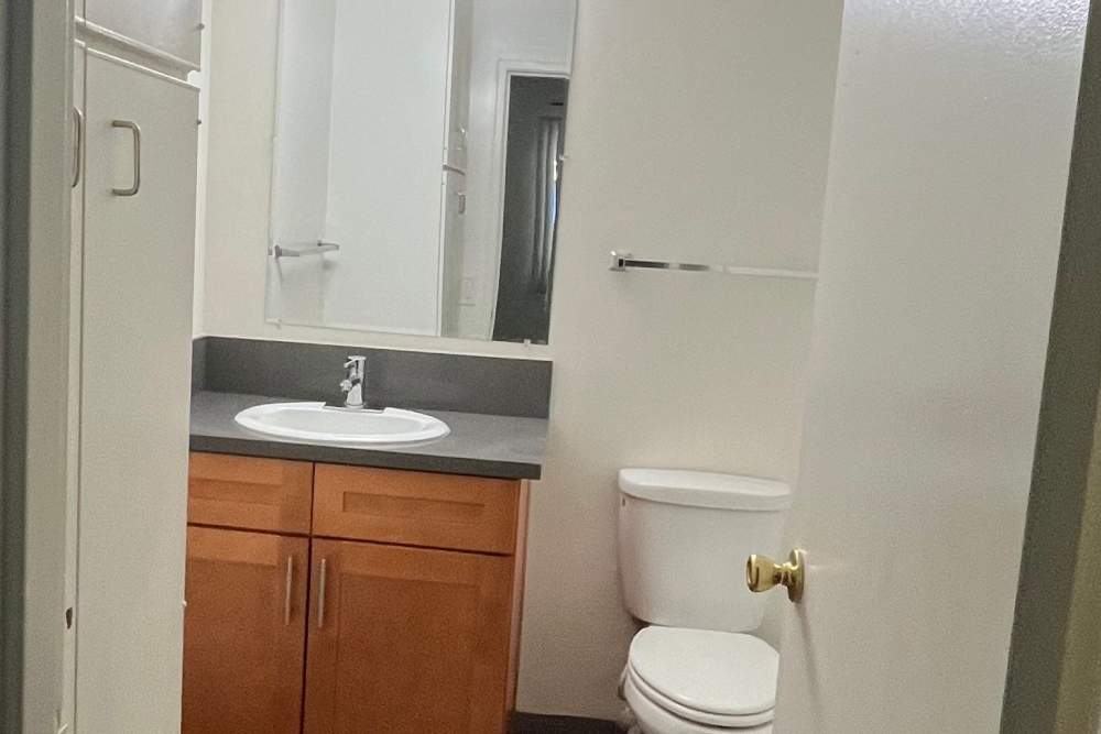 Bathroom with vanity mirror at Valley Pride Village in Sylmar, California