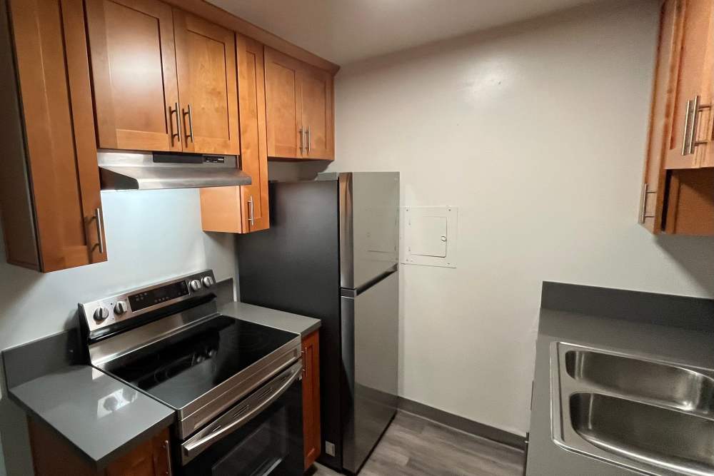 Kitchen with many cabinets at Valley Pride Village in Sylmar, California