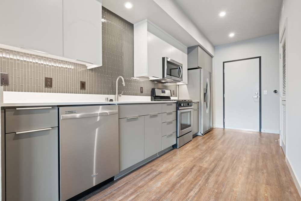 Kitchen with wood flooring at The George Apartment Homes in Anaheim, California